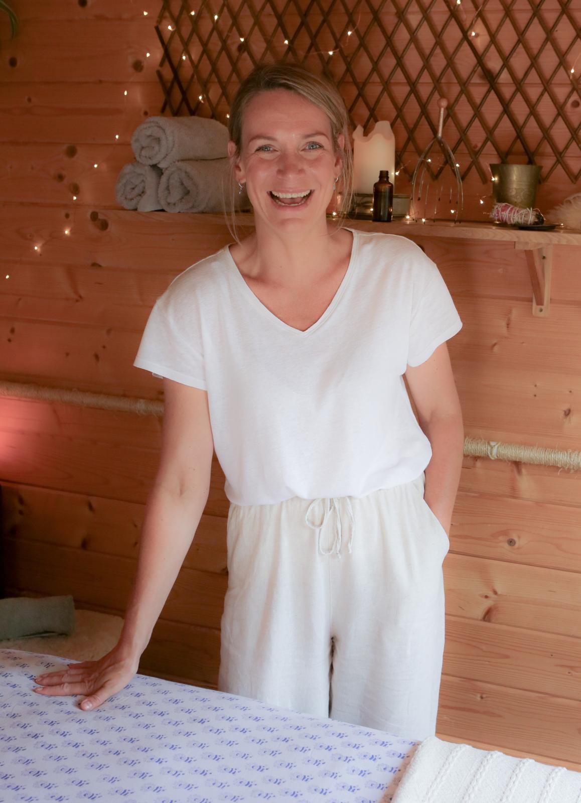Window view of green foliage from inside the hut.